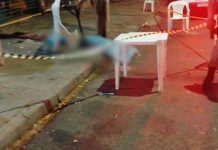 Idoso é preso após desferir facadas fatais contra homem no bairro Laranjeiras Viatura da Polícia Militar isolando área com fita amarela em cruzamento urbano à noite.